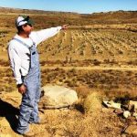 A Hopi Farmer pointing at his fields.