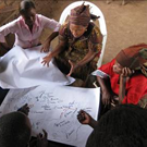 Tanzanian partners drawing a participatory map.